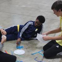 Students build a contraption to keep their egg intact for a Physics Olympics Activity
